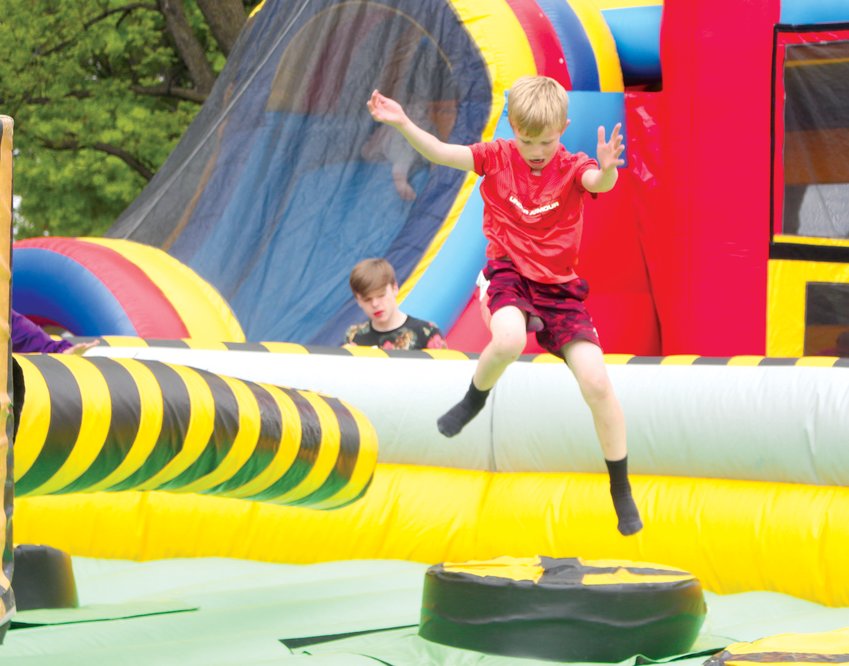 William Filows, 9, leaps over a moving obstacle course at the Blair Family YMCA Block Party on May 21.