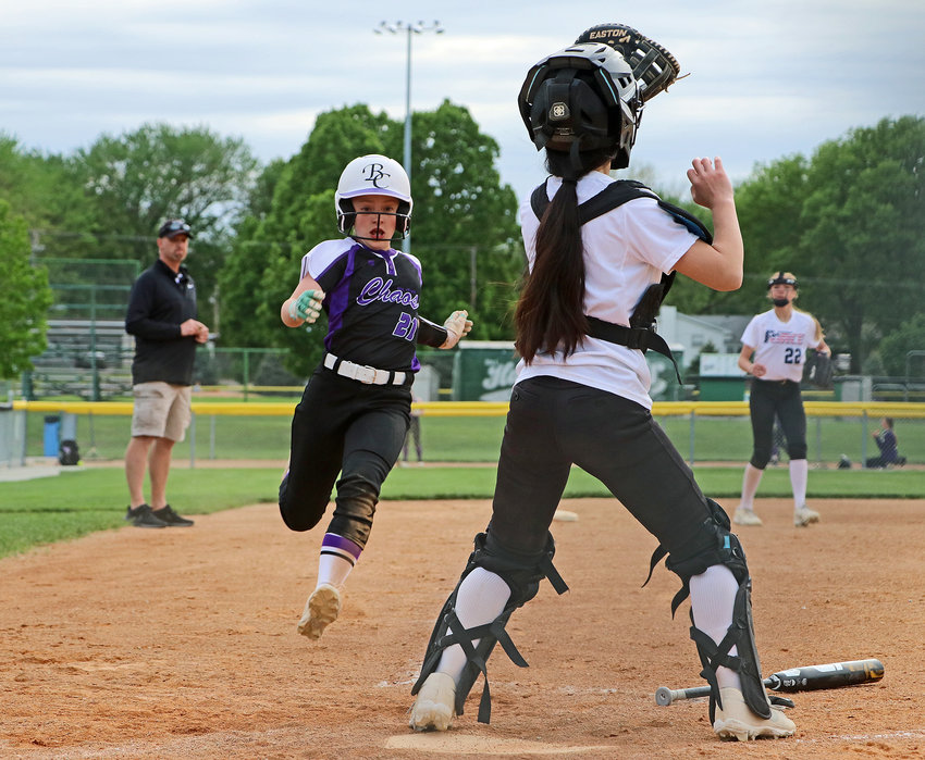 Age 11 and younger Blair Chaos base runner Nicole Dondelinger, middle left, sprints to home plate May 20 during the Gary Baker Invite at the Youth Sports Complex. Area teams competed in the Blair Youth Softball Association tournament May 20 through Sunday.