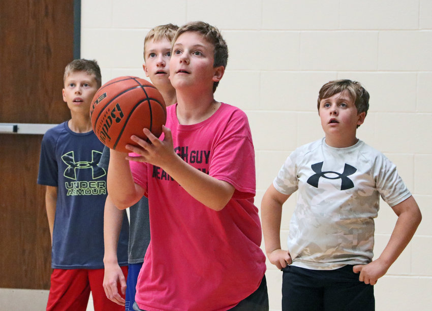 Kaden Haack, a soon-to-be seventh-grader, takes a shot as his fellow basketball players watch Wednesday at Blair High School.