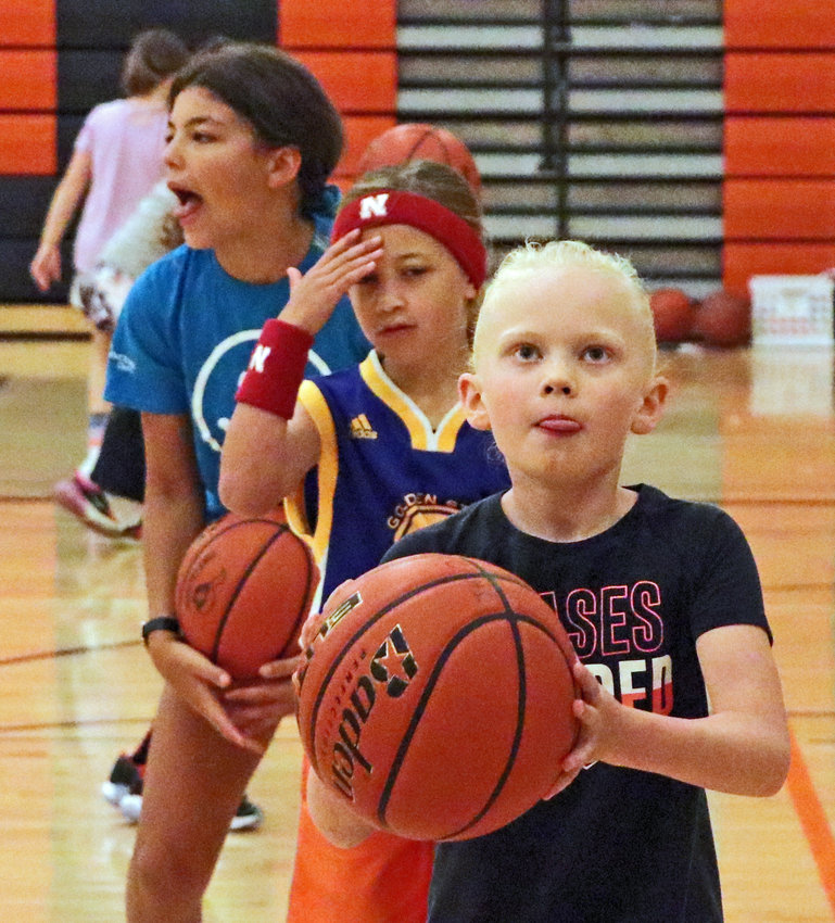 Sadie Dougherty, 8, reaches the front of the line and eyes the hoop Wednesday at Fort Calhoun High School.