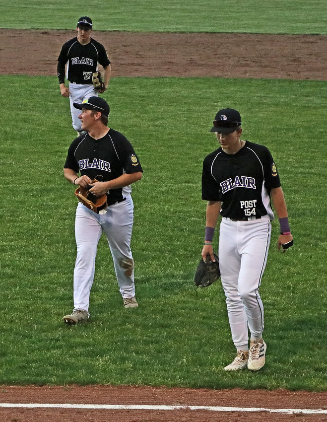 Blair Senior Legion baseball players Bo Nielsen, from left, Morgan Rump and Greyson Kay leave the field Tuesday during a lightning delay at the Omaha Home for Boys. The game was called off in the second inning shortly thereafter.