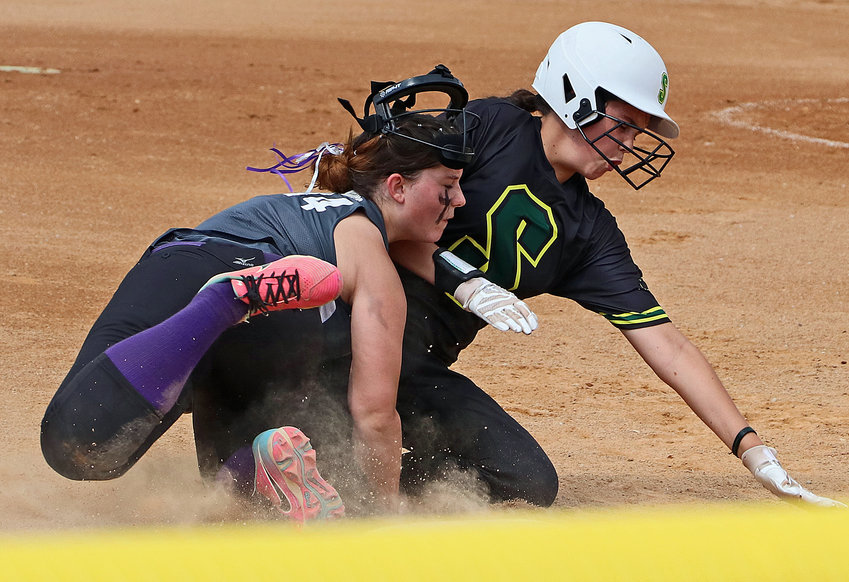 Blair Diamonds infielder Ella Jenkins, left, held onto the ball for an out through this collision with a Nebraska Storm base runner Saturday at the Blair Youth Sports Complex. The Diamonds were playing at home in the USA Softball of Nebraska 12U C District 8 Tournament.
