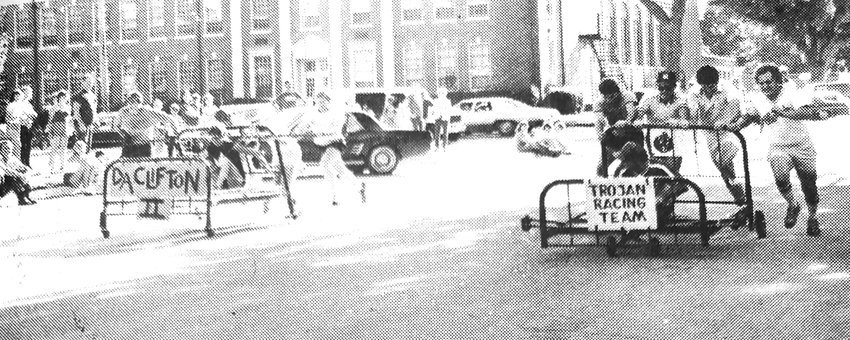 DA Clifton II, left, and the Trojan Racing Team compete during the 1983 Blair Farm-A-Rama Bed Races.