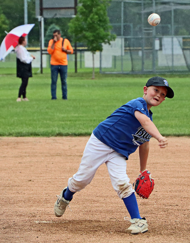 Blair Braves age 8 and younger right-hander Andrew Ell pitches in the rain Thursday at the Youth Sports Complex. Little Leaguers toughed it out as sprinkles dampened the bills of their ballcaps during regular season play.
