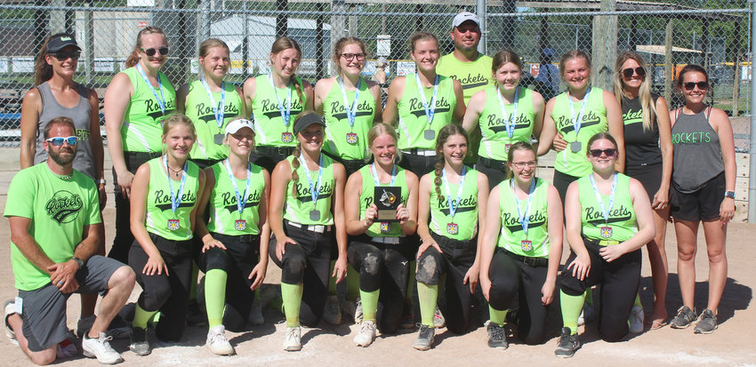The 2022 District Champions the Oakland-Craig Rockets 14/16's  in the 18's District tournament with their plaque and medals. They are from front left Coach Max Christensen, Madeline Pearson, Kara Selken, Laryn Johnson, Adi Rennerfeldt, Briar Ray, Lillian Ehlers and Natalie Christensen. Back row: Coach Nikki Ray, Emma Johansen, Bailey Denton, Bailey Pelan, Morgan Ray, Shea Johnson, Coach Andy Rennerfeldt, Karley Eriksen, Anisten Rennerfeldt, Coach Angie Rennerfeldt and Coach Mackenzie Charling.