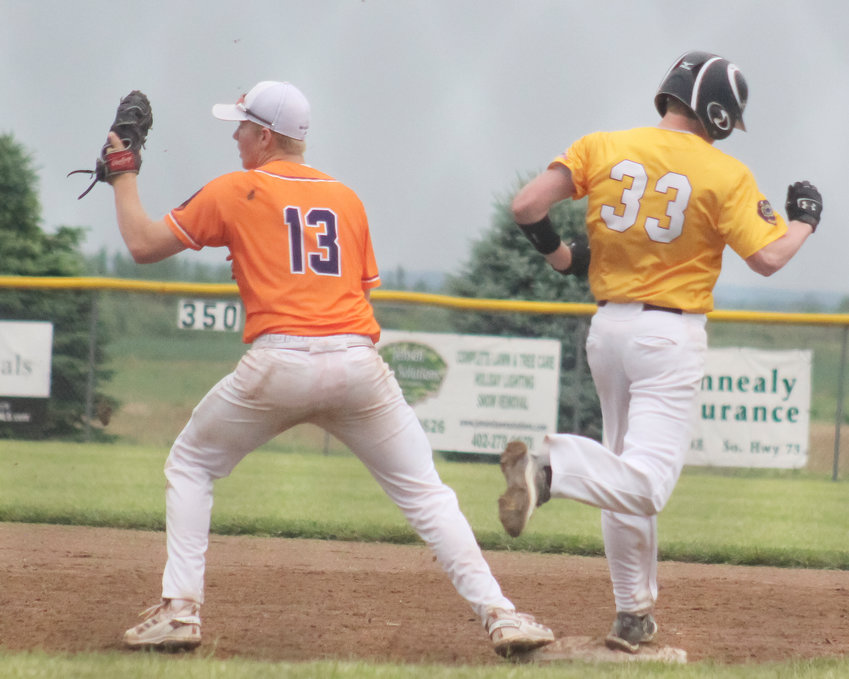 Nolan Magnusson catches the ball for the out at first base.
