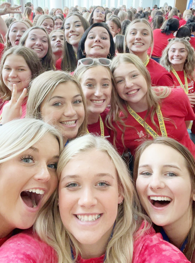 Wearing their red shirts, Johnna Peterson (center with glasses) and her fellow Staters show support for Veterans on Friday during their time at Girls State in Lincoln.
