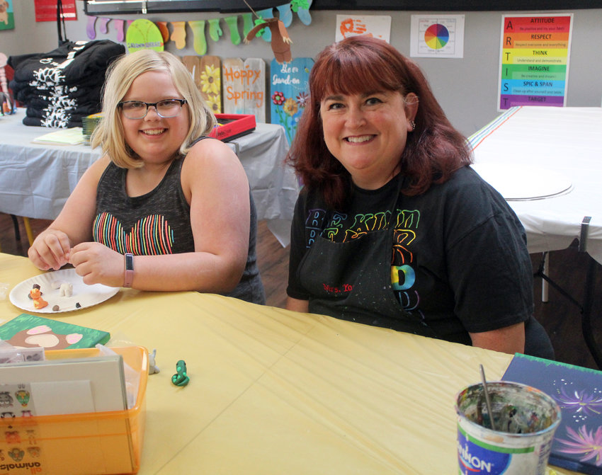 Addie Gochenour, left, and Cherri Yost make clay figurines Wednesday during a kids' art class at The Art Room. Yost, an art instructor and educator, teaches anyone from toddlers to adults at The Art Room, and said she wants all her students to embrace their creativity.