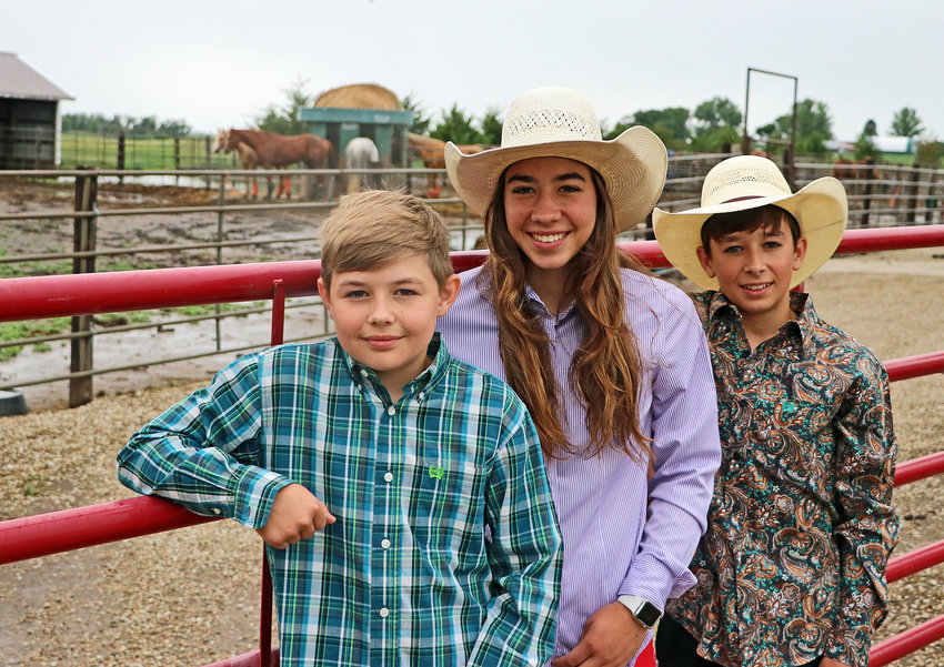 The Hegemann kids &mdash; Eli, from left, Libby and Haydn &mdash; pose for a photo on their farm June 15. Libby and Haydn qualified and are competing in national rodeos this summer.