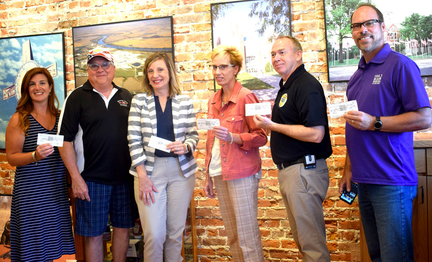 The Midwest Early Corvette Club presented checks to several entities. Pictured, from left: Jordan Rishel with the Washington County Chamber of Commerce, Midwest Early Corvette Club Chairman Doyle Eicher, Michelle Birkel with the Southeast Community College, Denise Cada with the Washington County Food Pantry, Blair Police Chief Joe Lager and Kelly Johnson with Blair Radio..