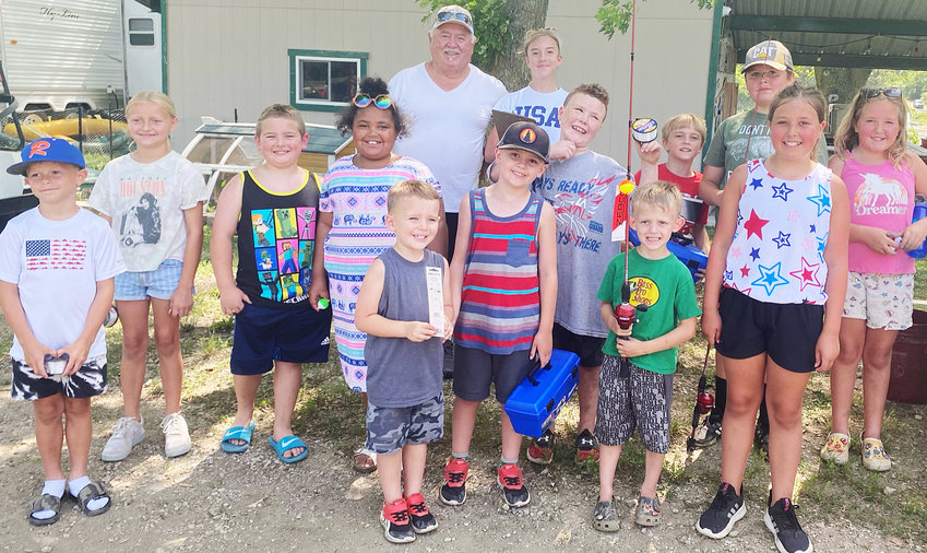 Winners of the fishing tournament with their prizes provided by Decatur Rock are pictured in the front. Winners were Meika Marriott (far right) with first prize.  Blaine Troutman was the third-place winner. Brothers Jakob and Parker won 2nd and 4th place.  You can see from the smiles that none of the kiddos cared about winning, they just had fun getting to fish.