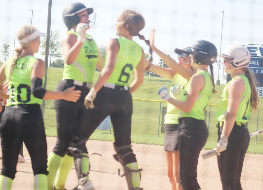 Shea Johnson comes in to home after hitting the homerun and celebrats with her sister Laryn and the other Rocket players