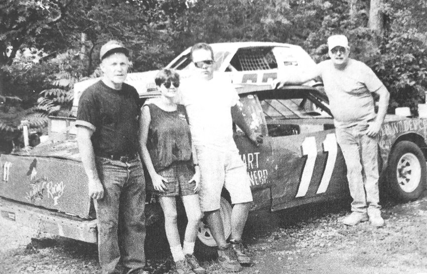 Joe Stewart, from left, Niki Wulf, Mark Wulf and Vernon Wulf pose for a photo with the 11S race car in summer 1994.