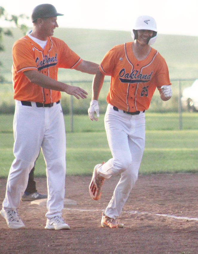 Gus Ray congratulates Carson Thomsen on hitting a homerun during the Ponca game.