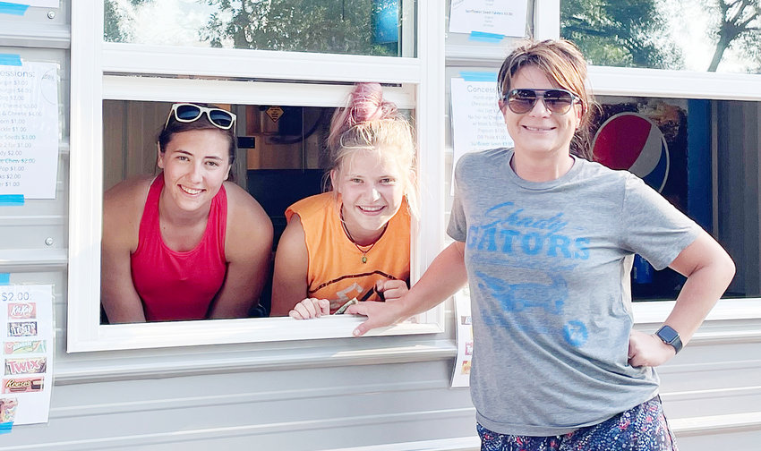 Makenna Pearson and Madeline Pearson serve Kate Webster at the renovated concession stand at the Oakland ball fields.