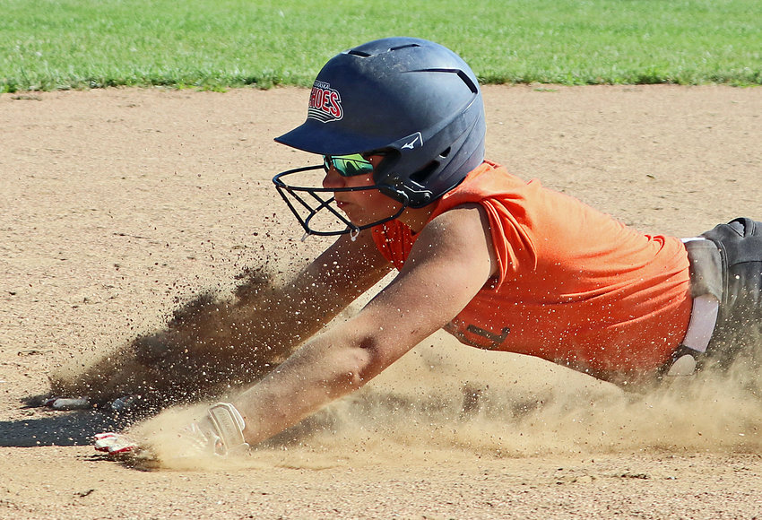 Pioneers junior Sam Brewer slides into second base June 29 during a camp session in Fort Calhoun.