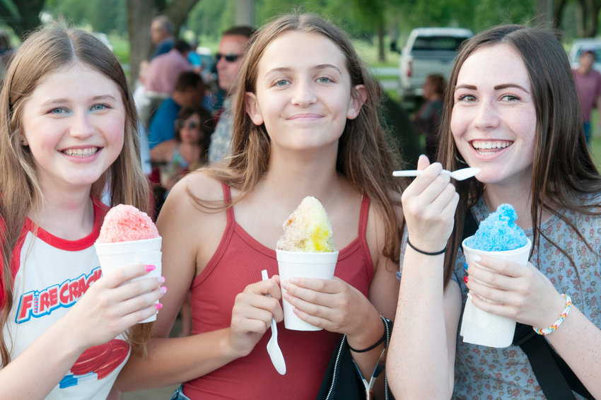 Cooling off on a warm day, Lyndsey Johnson, Brooklyn Richards and Grace Wallerstedt enjoy shaved ice from Newill&rsquo;s.