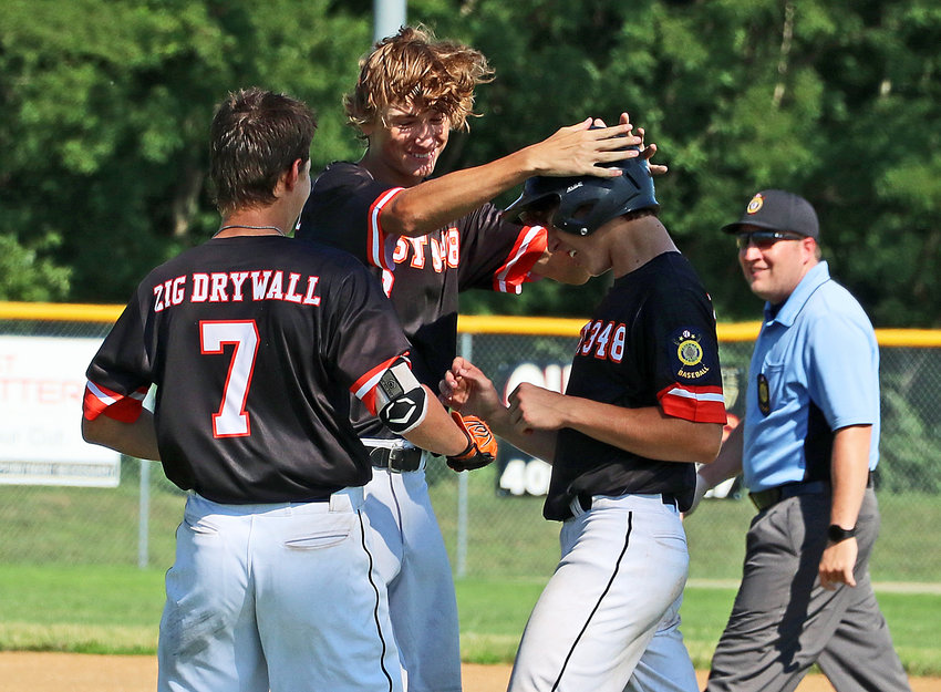 Fort Calhoun Junior Legion baseball players Kenny Wellwood, from left, and Jordan Back celebrate with Chase Premer after the latter's walk-off hit Saturday in Plattsmouth. The Post 348 Pioneers beat the Kelly Ryan Pride, 6-5, in eight innings.