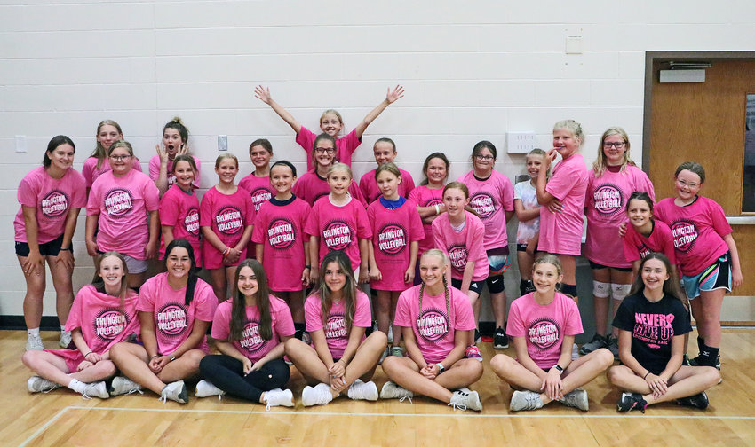 Eagles and campers pose for a photo July 13 during a volleyball camp at Arlington High School.