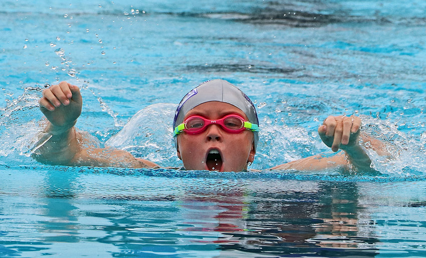 Isabel Chrans, 9, competes in the butterfly Saturday during a conference meet in Blair.