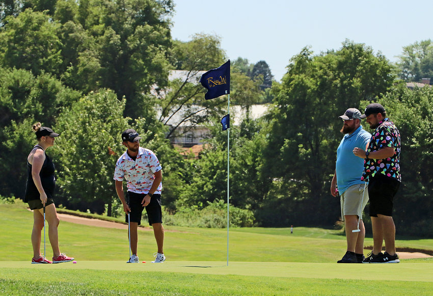 Rose Klein, from left, Justin Bray, Cody Petersen and TJ Bottorff play the 17th green Friday during the ninth annual Blair Wrestling Club Golf Outing at River Wilds Golf Club. Thirty-five teams took part during the event, which benefits the youth wrestling organization.