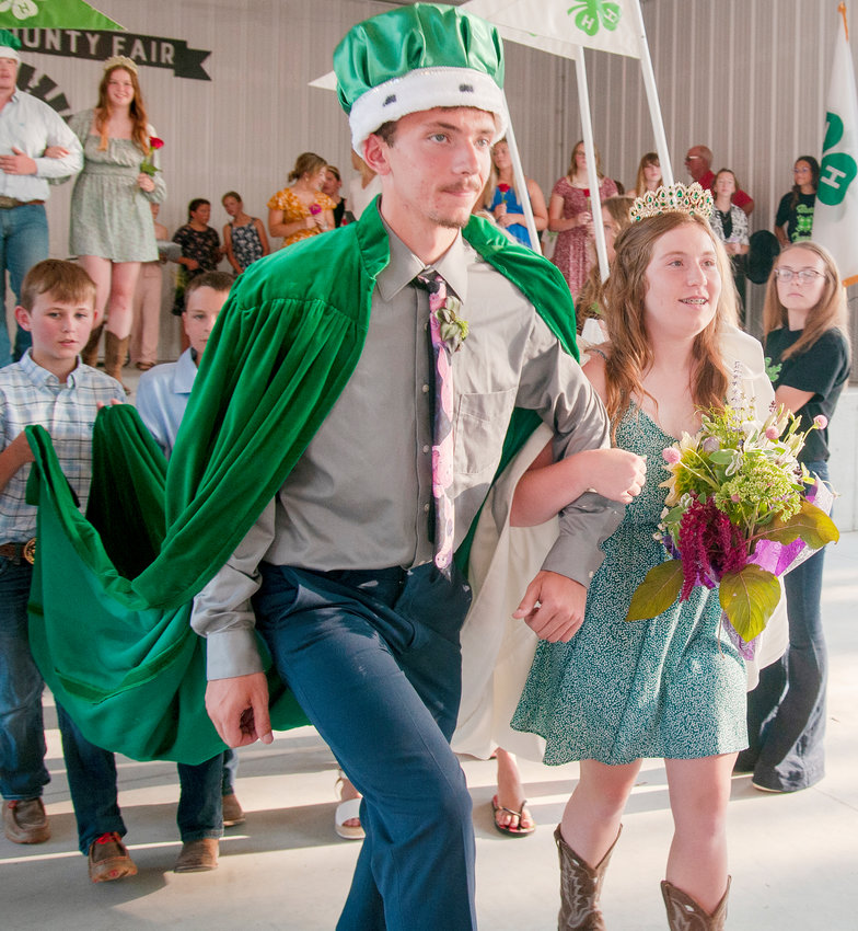 Caleb Schlichting (left) and Sydney Olsen (right) have the royal walk down as they win this years 4-H king and queen.