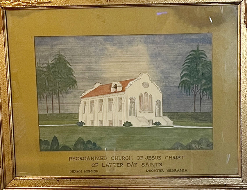 This water color painting of the Indian mission Church of the Latter-Day Saints was.purchased through an on-line auction by Jane Judt. The artist is unknown. The painting .hangs in The Church of Jesus Christ, Decatur Restoration Branch. It currently is on .display at the Decatur Museum. The Church stood North of Decatur from 1924 to 1945..The church stood alongside a farm where Native Americans were taught how to farm.  In.1945 the Stucco covered church was moved to Macy and renovated. Unfortunately, the church was later destroyed by a fire.