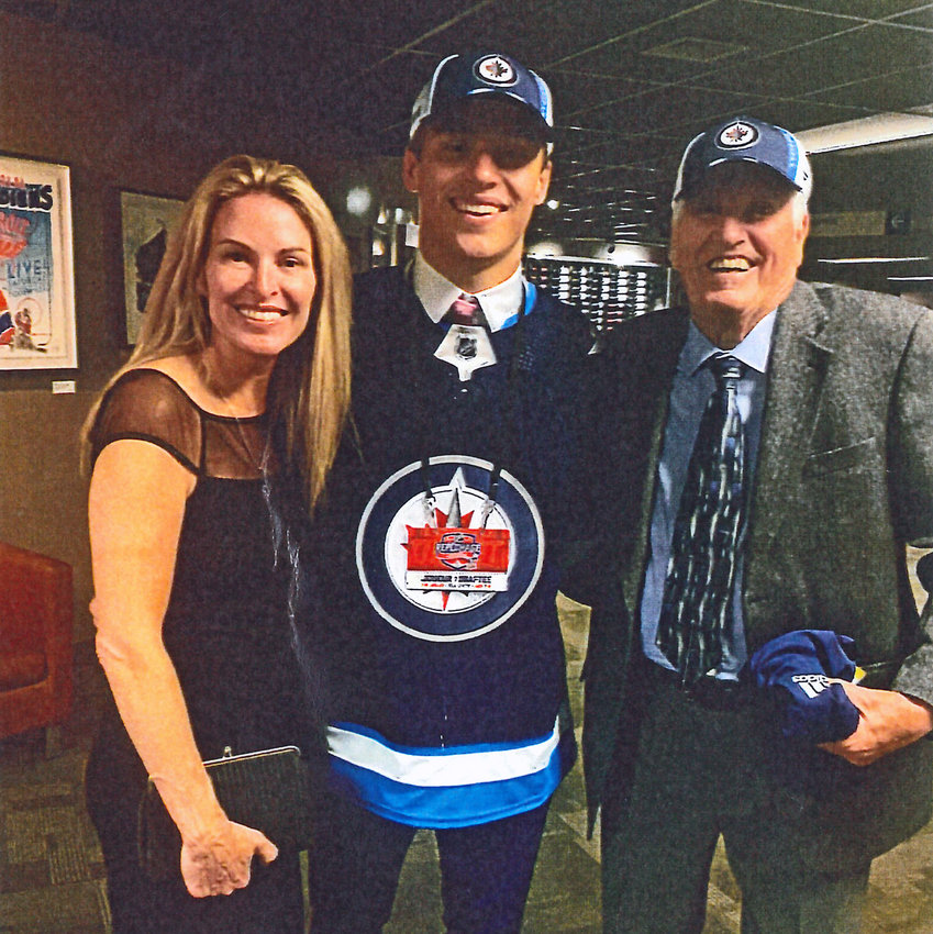 Roger Petersen of Blair, right, poses for a photo with his grandson, Rutger McGroarty, middle, and daughter, Cindy Petersen McGroarty, after Rutget was selected by the Winnipeg Jets during the 2022 NHL Draft in Montreal.