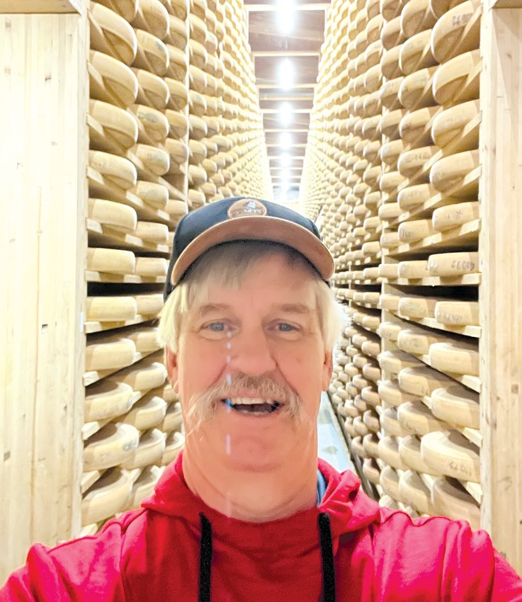 Lee Anderson, Fort Calhoun, stands in front of thousands of wheels of Comte cheese at Fort de Saint Antoine in France.