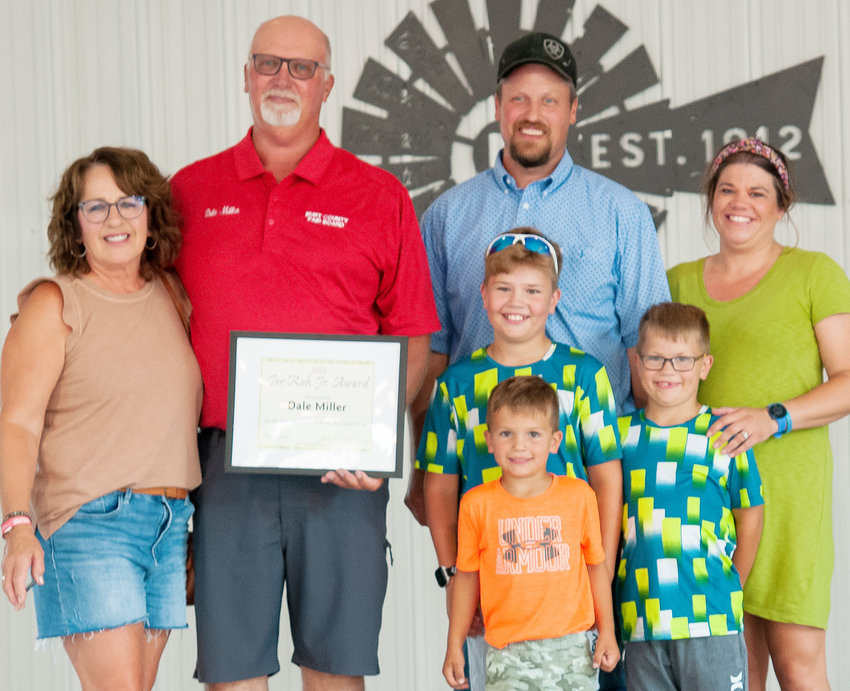 Burt County Ag Society President Dale Miller is joined by his wife Paula, son Stuart and Leah Miller and their three children Carsyn, Trent and Becket Miller, as he received the prized Joe Roh, Jr. Service Award at the Burt County Fair.
