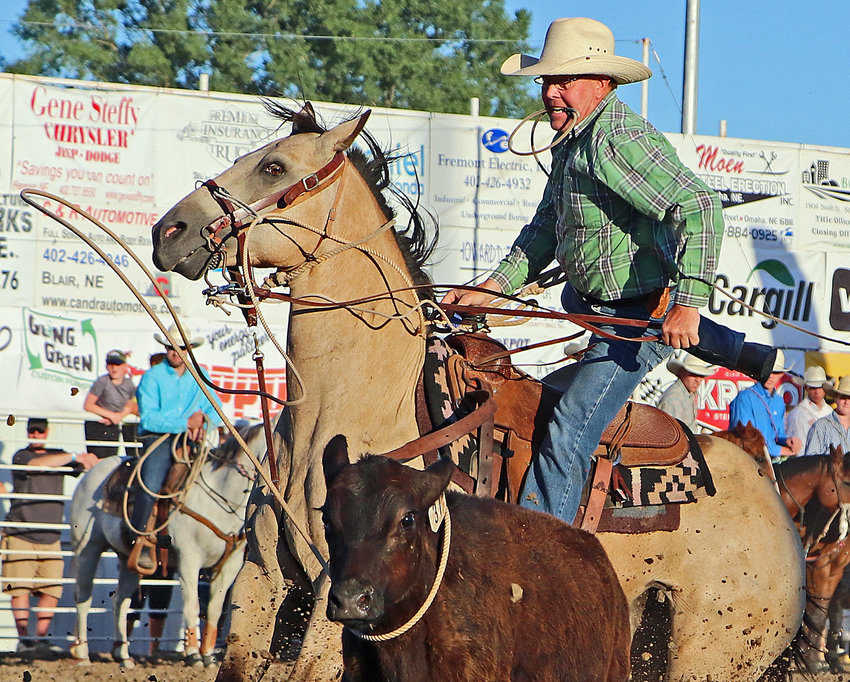 JL Spurgeon of Mullinville, Kan., dismounts from his horse in the tie-down roping Saturday during the Washington County Fair Rodeo in Arlington.