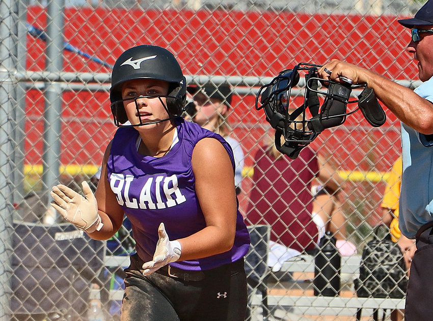Blair's Kenna Nielsen celebrates a safe slide across home plate Friday during The Freshman State Softball Tournament in Lincoln.
