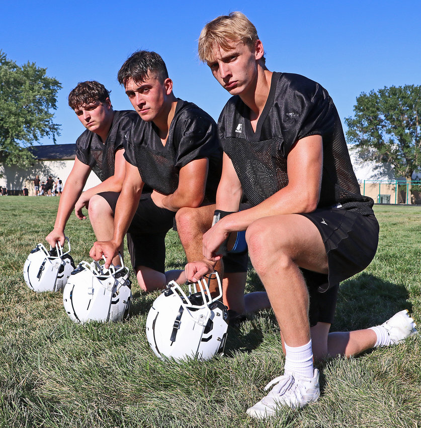 Kyle Quinn, from left, Cade Podany and Kaden Foust will play important roles on the Arlington High School football team this fall.