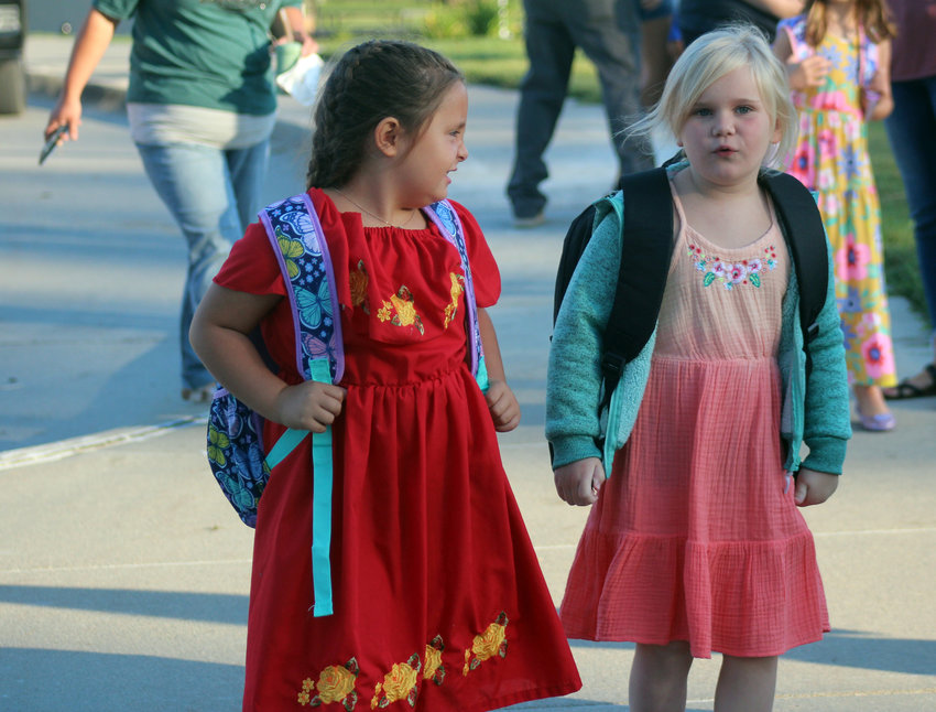 Cora Westphalen, left, and Jemma Winterberg chat before their first day of school at Fort Calhoun Elementary School Thursday morning.