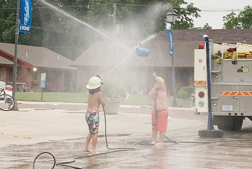 These two kiddos could be firefighters in training. Before long they could be using more than just a garden hose.