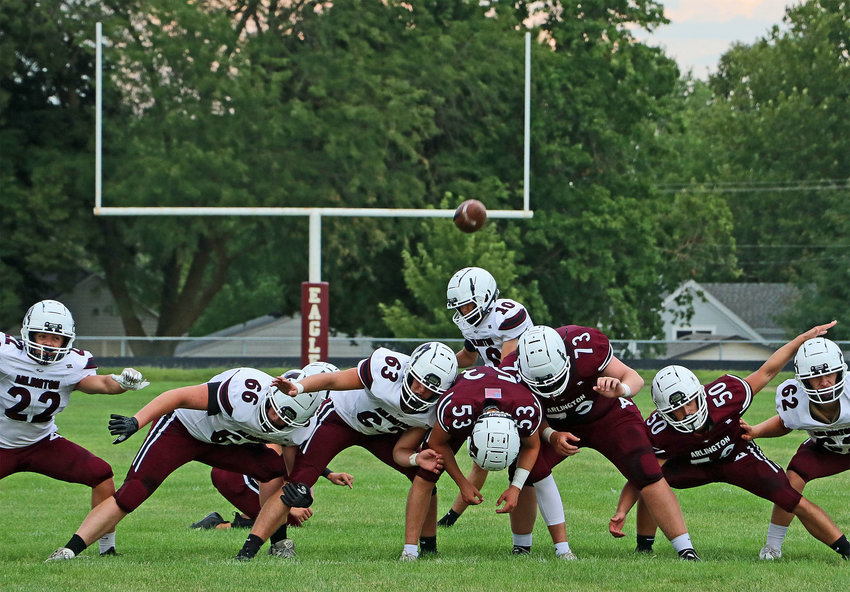 Colton Willmott (10) kicks over his Eagles offensive line Aug. 19 during the Arlington Booster Club Scrimmage at AHS. The blockers are Killian McIntosh, from left, Kyle Quinn, Kolton Gilmore, Braden Monke, Zane Gerrish, Cade Podany and Weston Wollberg.