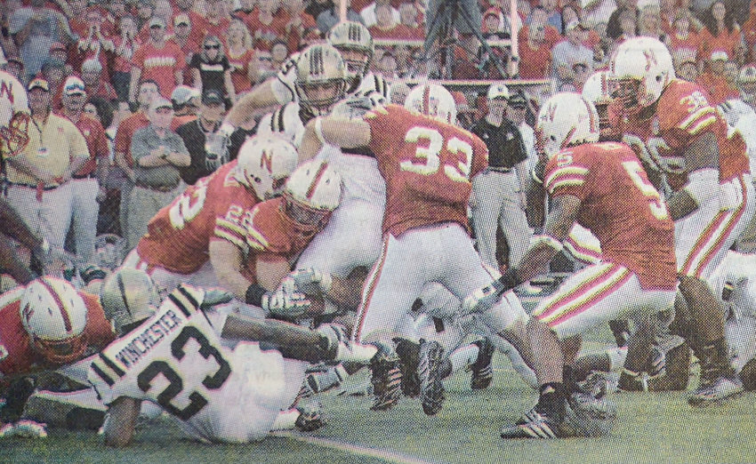 Nebraska Cornhusker Thomas Grove, middle, number not visable, drives his shoulder pads into the mid-section of a Western Michigan kick returner in 2008. The 2007 Arlington High School graduate played linebacker for position coach Mike Ekeler, a Blair High School grad.