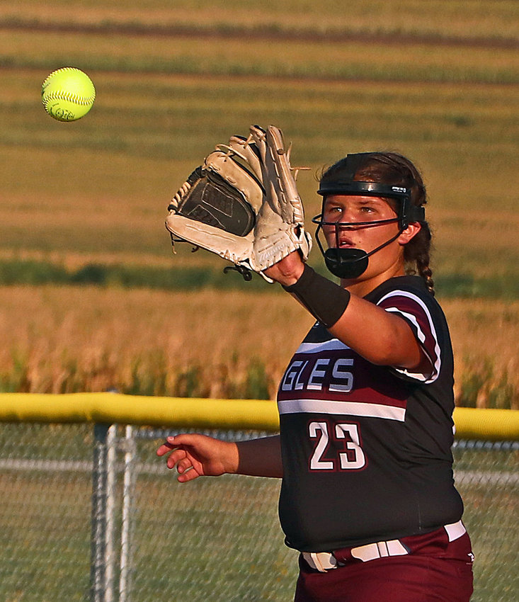 Arlington junior Rylee Fuehrer watches the ball into her glove at first base Thursday at Two Rivers Sports Complex.