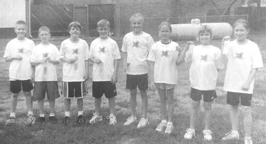Winners of a 2005 Arlington Elementary School cross-country meet pose for a photo. They are Christopher Gorton, from left, Jack Scott, Matt Mellema, Cory Moravec, Heather Johnson, Lauren Mues, Jackie Dam and Julia Anderson.