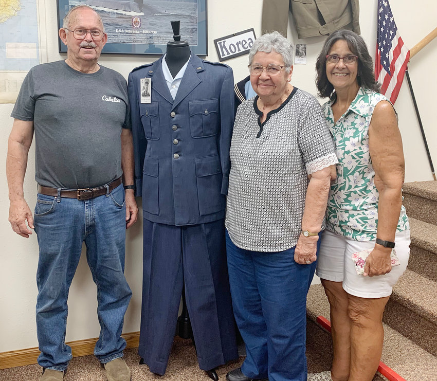 The Edward Anderson family traveled from northern California to New York, searching for information on Marsh family ancestors. They were at Burt County Museum recently, where they discovered information on Marsh family ancestors at local cemeteries. With help from museum staff, they were able to locate some family at Arizona Cemetery. Standing with William Marsh&rsquo;s Air Force uniform in the main floor military room in the East House are, from left, Edward and Jinny Anderson and their daughter, Laurie Thomas.