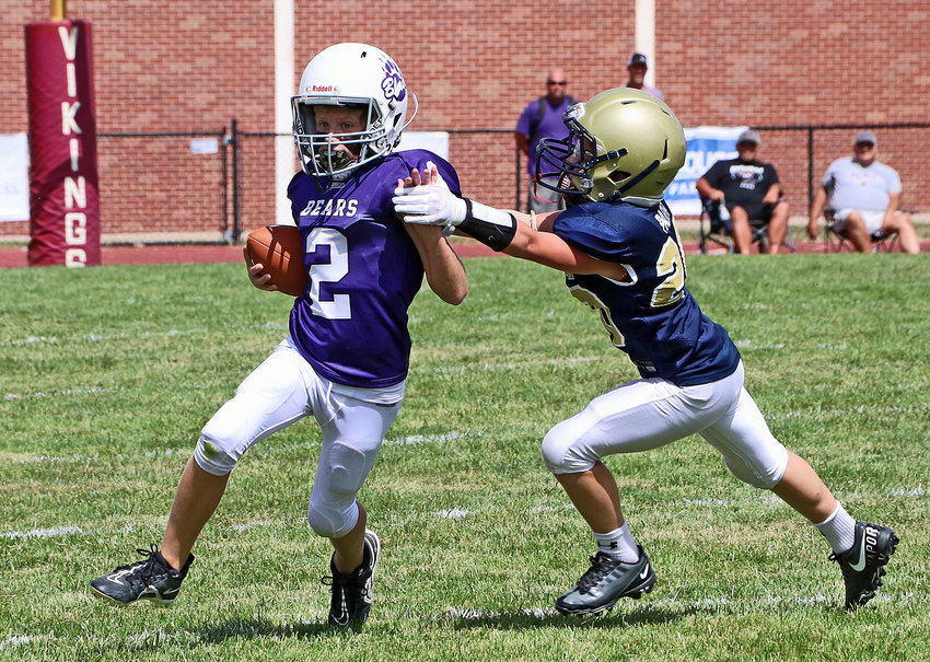 Blair Youth Football Association fifth-grader Grady Grabbe, left, avoids the tackle of a EAA Jr. Storm tackler Sunday on the former Dana College football field. The fifth-grade Jr. Bears won 12-0 as Blair teams went 3-2 during the opening weekend of the Metro Youth Football League season. The third-grade Bears beat a South Omaha Athletics team 16-0, while the fourth-grade BYFA team topped the Millard North Jr. Mustangs 30-6.