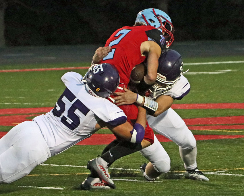 Blair defenders Brayton Osius, left, and Kaden Sears, right, combine to take down the Rams' Hudson Holloway on Friday at Ralston High School.