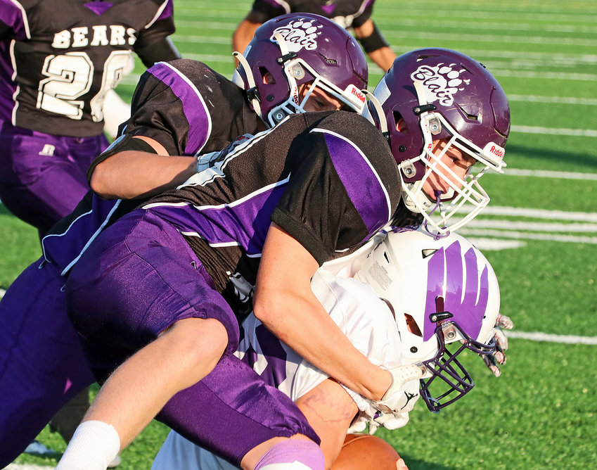 Hayden Daggett and a Blair freshman football teammate tackle a Lincoln Northwest Falcon on Monday at Krantz Field. The ninth-grade game was the first of three Bear home games this week. The last is tonight as the BHS varsity takes on Omaha Gross.