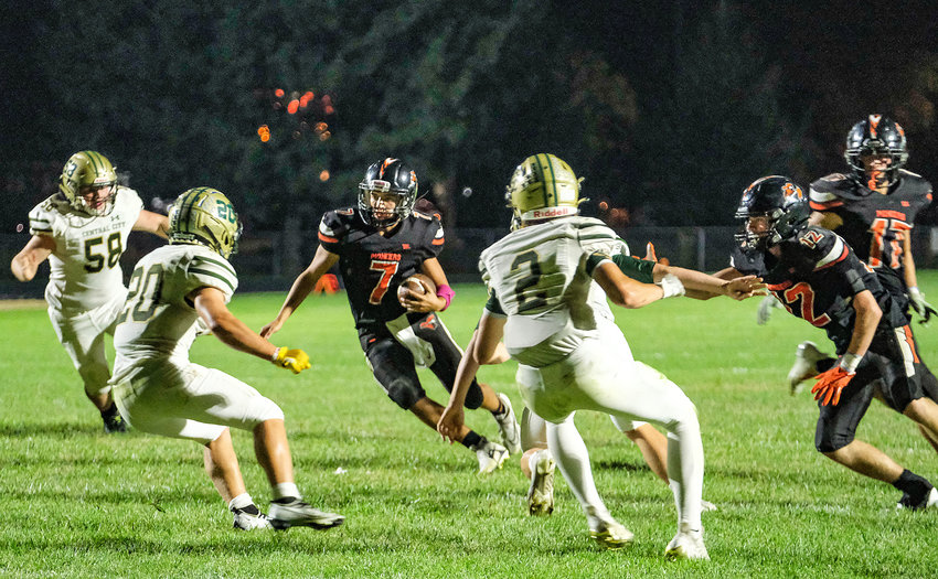 The Pioneers' Austin Welchert, third from left, carries the ball against Central City on Friday at Fort Calhoun High School.