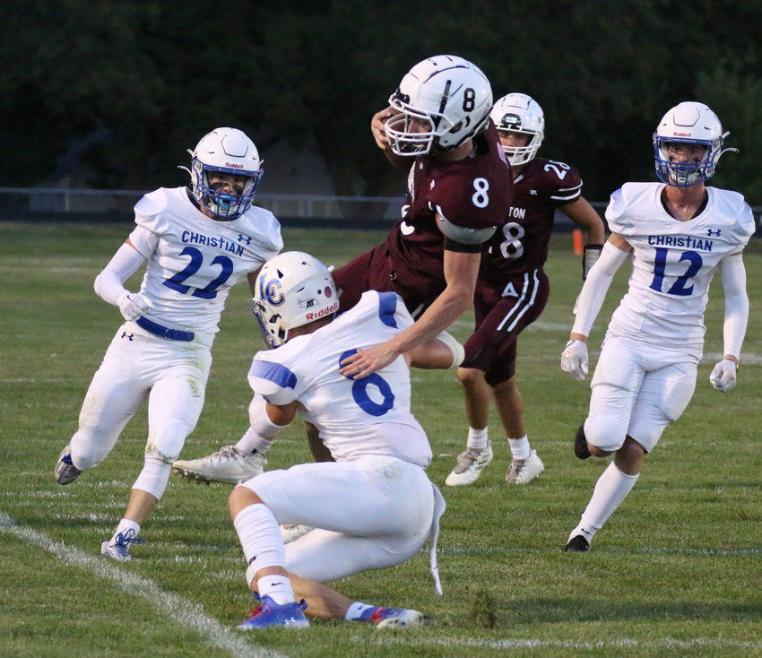Arlington quarterback Kaden Foust catches air trying to avoid Lincoln Christian defenders during the Eagles' 32-7 loss on Sept. 16.