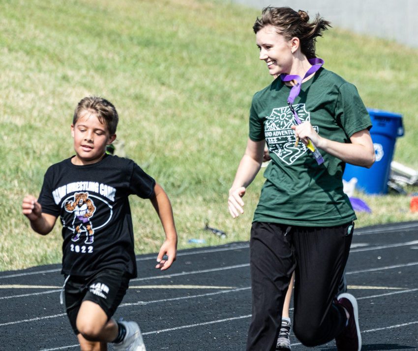 Arbor Park teacher Jaclyn Renken runs with fourth grade students during the PTO Fun Run on Sept. 16.