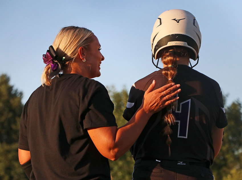 Blair High School softball coach Jennifer Fangmeier, left, encourages Joslyn Policky before the catcher bats against Hastings on Monday at the Youth Sports Complex.