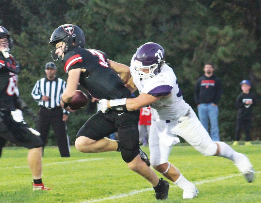 Dane Larsen (37) gets to the quarterback during Blair's 23-3 win over Mount Michael on Friday night.