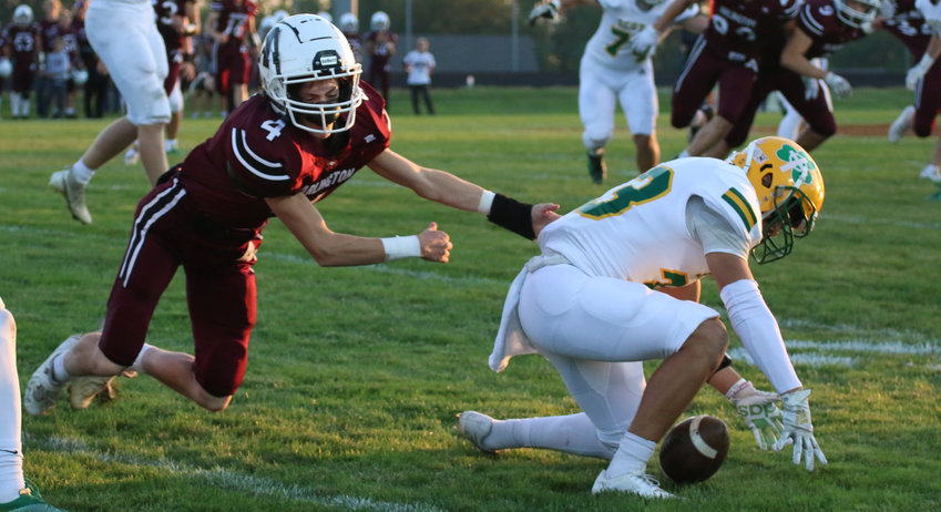 Arlington's Cooper Staats attempts to cover Scotus Central Catholic's Eli Jarecke after he fumbled the ball Friday in the Shamrocks 35-8 win over the Eagles. Staats, a sophomore, also played quarterback throughout the evening and completed a touchdown pass to teammate Kaden Foust.