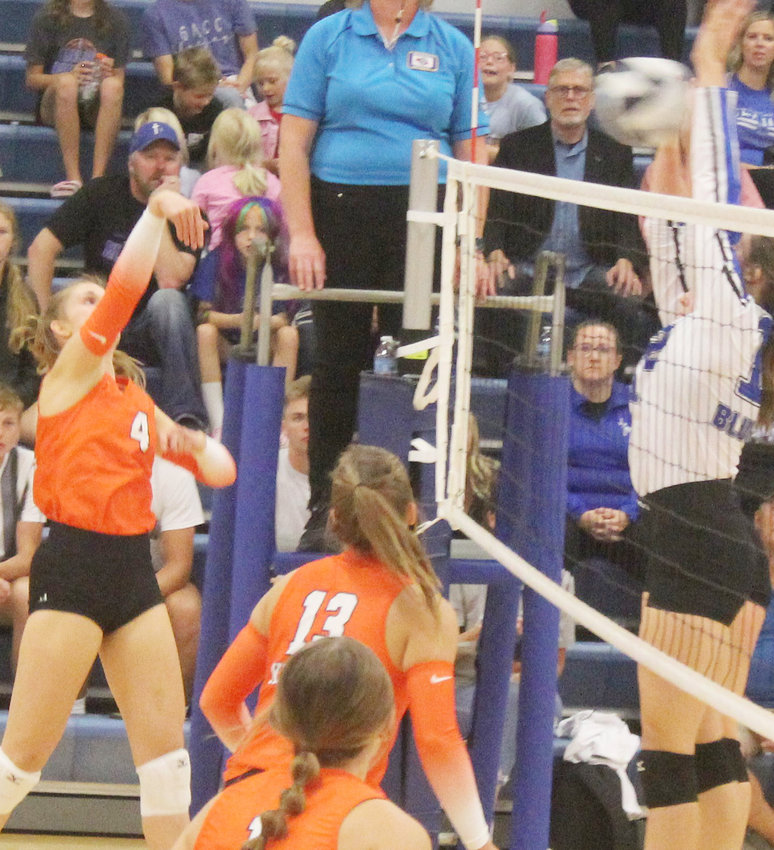 Syd Guzinski angles the hit over the net to avoid the GACC blockers.